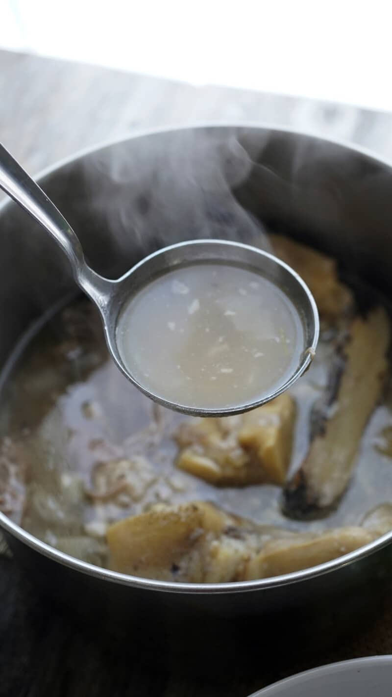 Step-by-step process of making pho broth in a large pot
